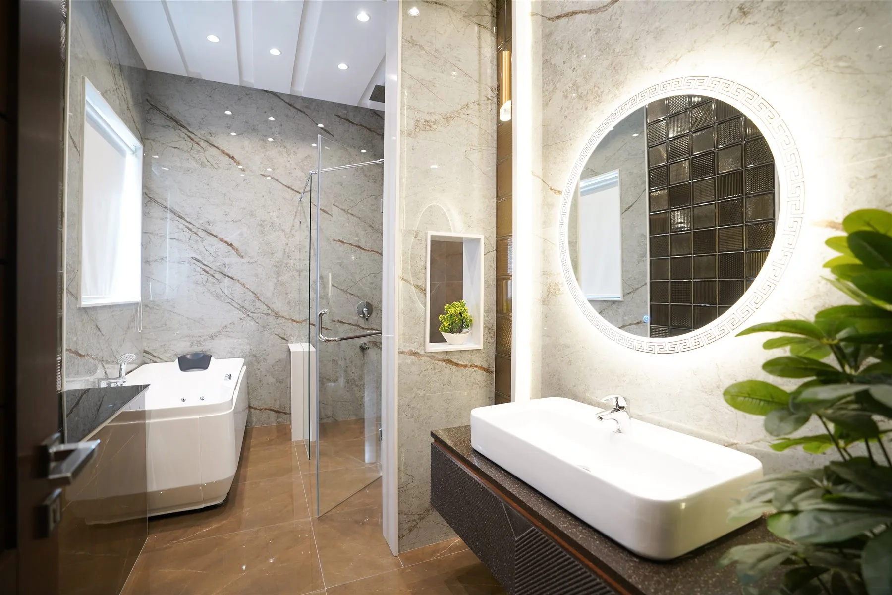 Bright finished bathroom with a freestanding tub, double vanity, and glass shower