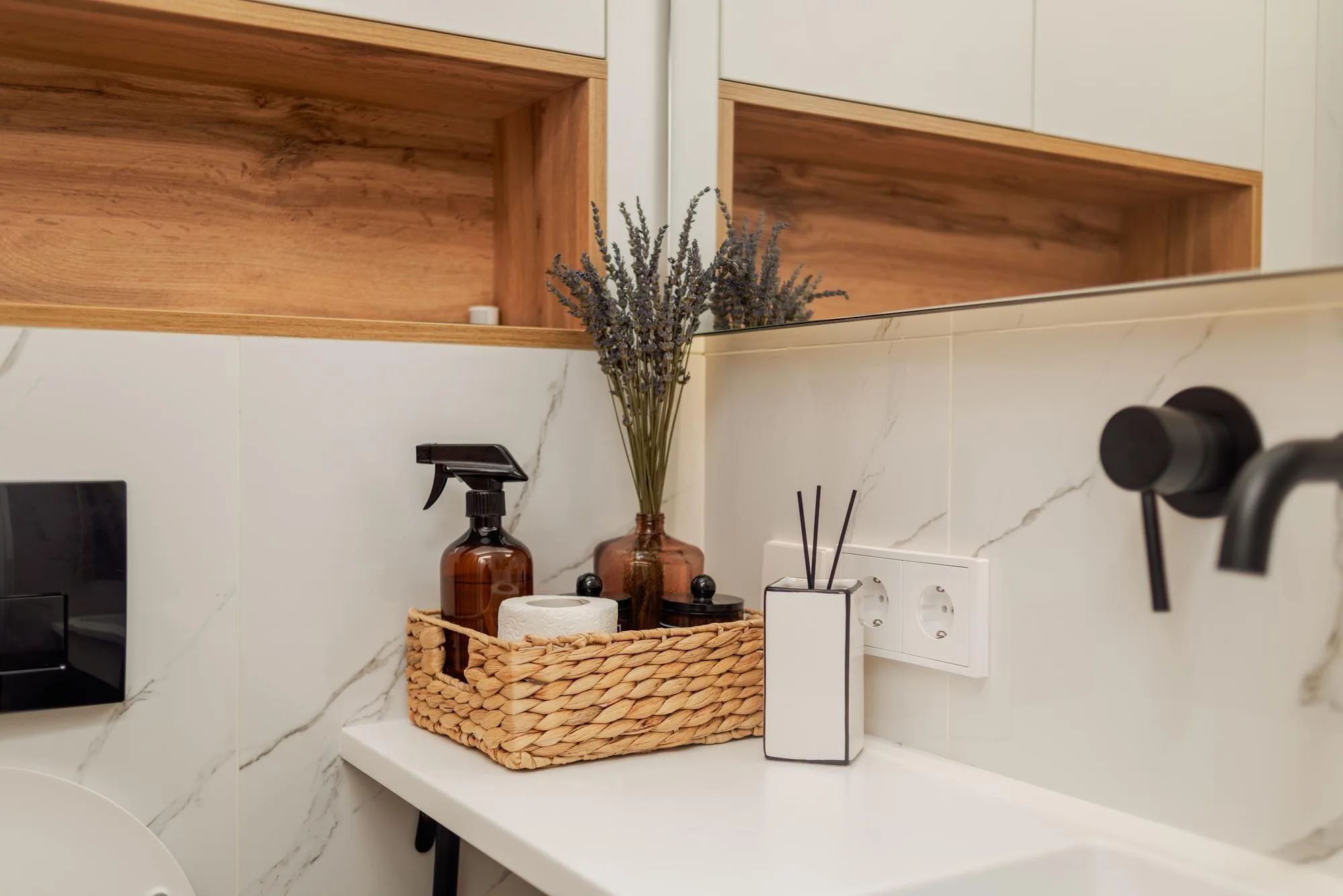 Residential bathroom counter with open wood storage and daily-use accessories